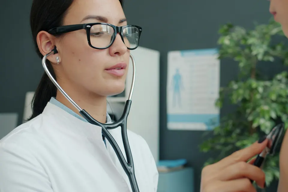 Doctor listening to a patient’s breathing with a stethoscope